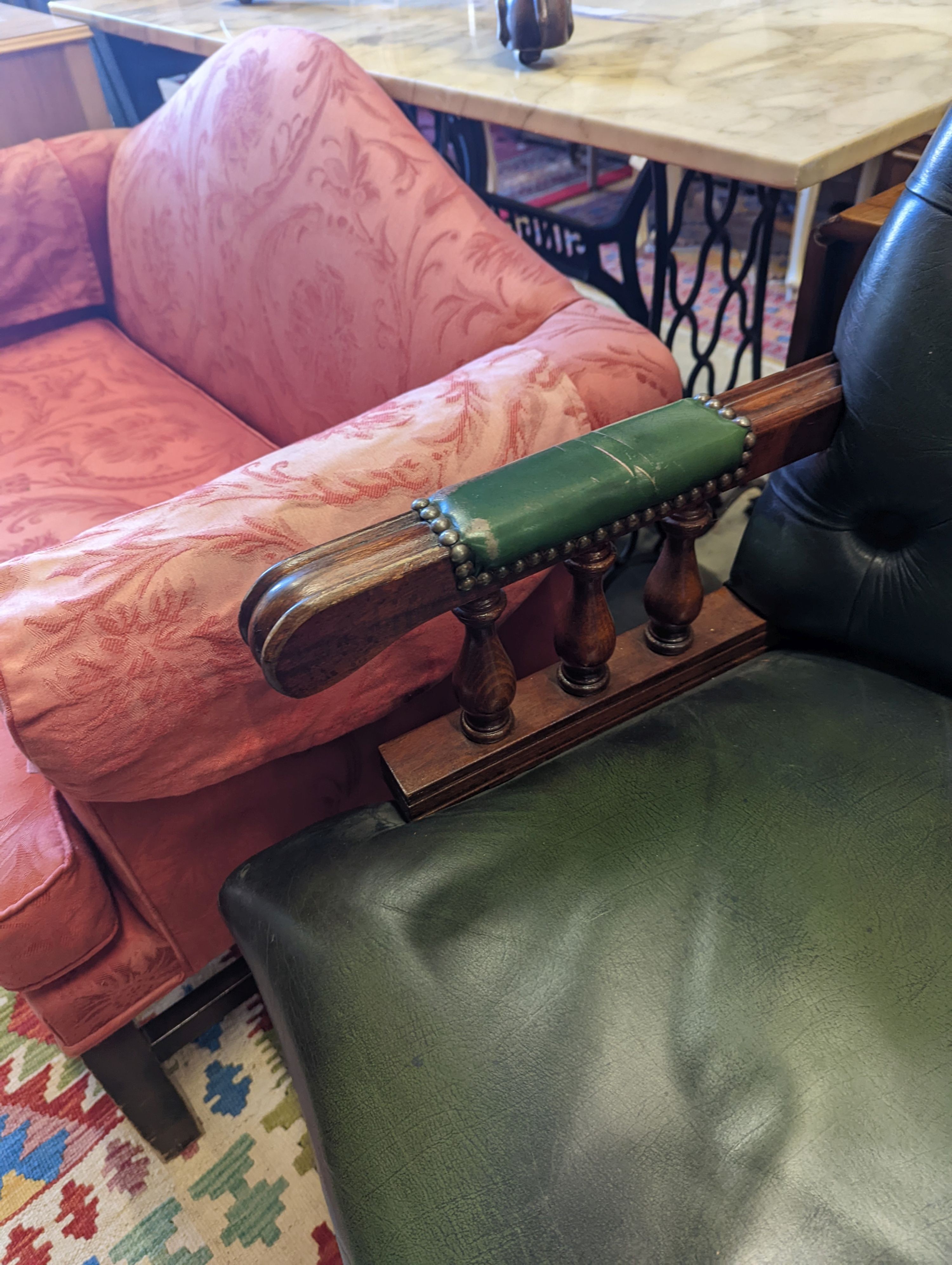 A green leather upholstered desk chair, width 60cm, depth 56cm, height 110cm